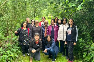 A group of people surrounded by greenery