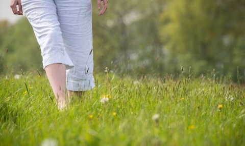 Woman walking through grass