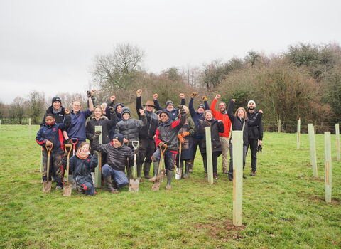 Group of people tree planting at James Adler nature reserve